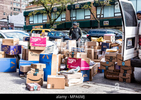 La città di New York, Stati Uniti d'America - 30 Ottobre 2017: Consegna uomo con molte caselle in NYC da BH foto video store, van carrello scarico di perfezione del Amazon, Walmart, fragrante, Foto Stock