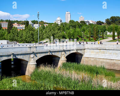 Puente del Rey ponte sul fiume Manzanares a Madrid Rio alla giornata di primavera con il Principe Pio e a Plaza de Espana in background. Foto Stock