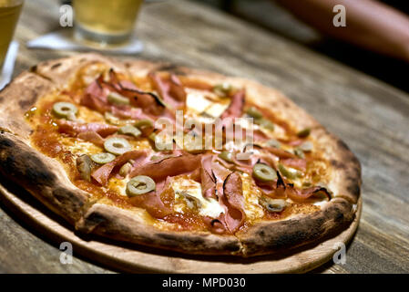 Pizza su una tavola di legno Foto Stock