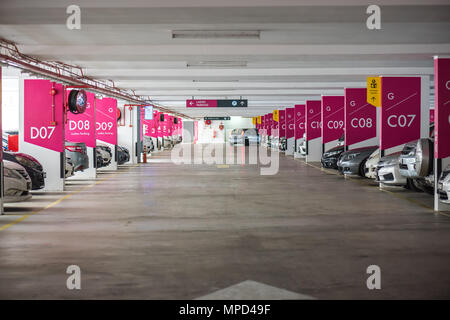 Metropolitana garage interno parcheggio con molte vetture con colleghe parcheggio segno bordo. Foto Stock