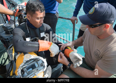 Stati Uniti Navy Hospital Corpsman 1a classe Virgilio Newton, un Seabee con costruzione subacquea Team Due, assiste Petty Officer di prima classe Kumwong Somsak, con il Royal Thai Navy Diving Training Center, durante operazioni di immersione per Cobra Gold 2017 in Sattahip, Chonchuri, Thailandia, Feb 15, 2017. Cobra Gold è il più grande esercizio multilaterali in Indo-Asia-regione del Pacifico ed è parte integrante dell'impegno degli Stati Uniti per rafforzare l'impegno nella regione. (U.S. Navy combattere la fotocamera dal capo della comunicazione di massa specialista Christopher Dallaglio) Foto Stock