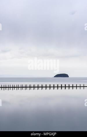 La causeway lungo il lago marino a Weston-super-Mare Lungomare con ripidi Holm isola nel Canale di Bristol al di là, North Somerset, Inghilterra. Foto Stock