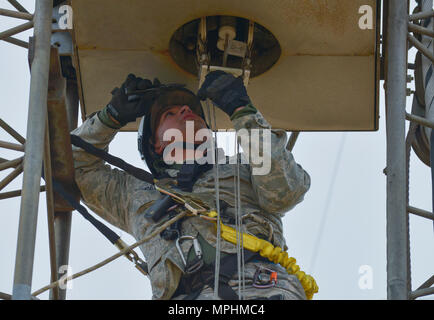 Senior Airman Javier Calvo, 374 Squadrone di comunicazione via cavo e sistema di antenna tecnico, lavora per rimuovere una linea di trasmissione su un organo girevole log periodic antenna alla comunicazione Tokorozawa Sito, Giappone, 14 marzo, 2017. La linea di trasmissione fornisce la frequenza di trasmissione del comando di sito per il sito di ricezione. (U.S. Air Force photo by Staff Sgt. David Owsianka) Foto Stock