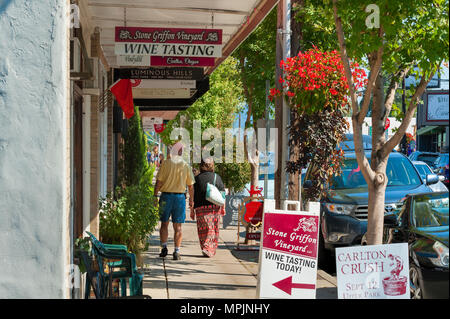 Carlton, Oregon, Stati Uniti d'America - 12 settembre 2015:la gente a piedi il marciapiede nel centro cittadino di Carlton, Oregon durante il vino annuale festival di schiacciamento. Segni entrambi hangi Foto Stock