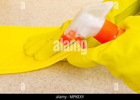 Mano nel guanto di gomma pulisce una nuova cucina. Donna con i lavori domestici, pulizia della cucina. Foto Stock