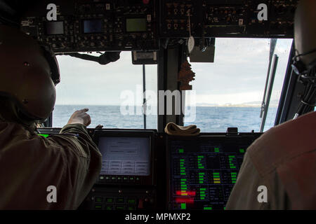 170405-N-WF272-0071 acque vicino KIN BLUE BEACH, Okinawa (5 aprile 2017) Landing Craft Air Cushion (LCAC) 29 navigator Electronics Tecnico 2a classe Patrick Johnson, sinistra, da Buffalo, N.Y., assegnato alla spiaggia navale unità (NBU) 7, punti su una spiaggia del punto di atterraggio durante un trentunesimo Marine Expeditionary Unit (MEU) offload dall'assalto anfibio nave USS Bonhomme Richard (LHD 6). Bonhomme Richard, ammiraglia del Bonhomme Richard Expeditionary Strike gruppo, con avviato 31 MEU, è su una pattuglia, operando in Indo-Asia-regione del Pacifico per migliorare la prontezza combattimento e la postura in avanti come un Foto Stock