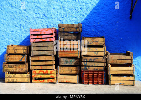 Vecchie scatole di legno per frutta e verdura impilati in una strada a Chefchaouen, Marocco Foto Stock