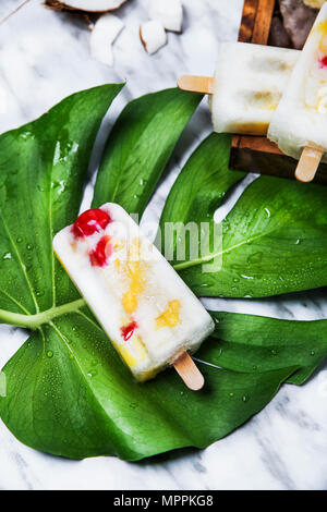 La Pina Colada ghiaccioli con ciliegie candite e ananas sulla lamina Foto Stock