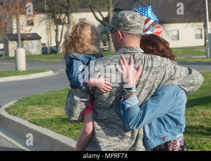 Master Sergeant assegnato al 46th Aerial Port Squadron serve nella United States Air Force come artigiano del trasporto aereo all'interno del 512th Airlift Wing. Dover Air Force base nel Delaware funziona come la stazione di origine dell'unità. Questa immagine d'archivio registra una riunione con il coniuge e i figli dopo un dispiegamento di sei mesi alla base aerea di al Udeid, in Qatar, l'11 aprile 2017. Foto Stock