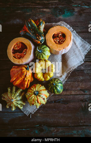 Varie le zucche ornamentali su stoffa e legno Foto Stock