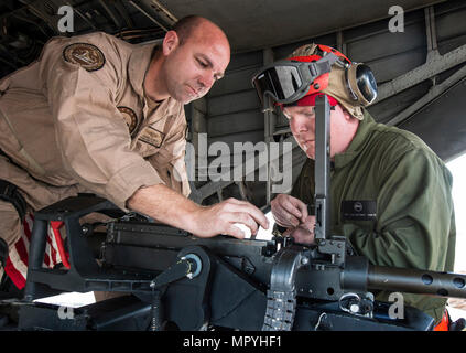 170420-N-TB410-0016 GOLFO ARABICO (apr. 20, 2017) Aircrewman navale di prima classe Chris Leebeck ,a sinistra e aviazione Ordnanceman 1a classe Edward Salsberry, assegnato all'Blackhawks di elicottero di contromisure Mine Squadron (HM) 15 distacco 2, preparare un GUA-21 .calibro 50 mitragliatrice sul retro di un MH-53E mare Dragon prima di una evoluzione di formazione al largo del Bahrein. HM-15 è assegnato alla Task Force 52, promuovere la mia attività di contromisura NEGLI STATI UNITI Quinta Flotta area di operazioni. (U.S. Foto di Marina di Massa lo specialista di comunicazione 1a classe Joshua Bryce Bruns) Foto Stock