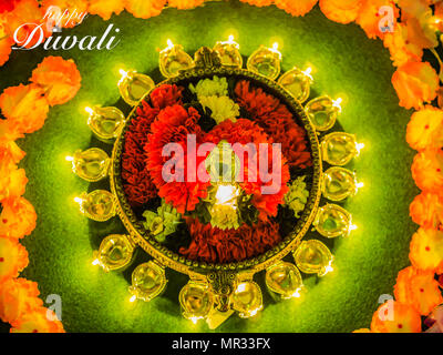 Argilla tradizionali diya lampade accese con fiori per il Diwali Festival celebrazione. Foto Stock