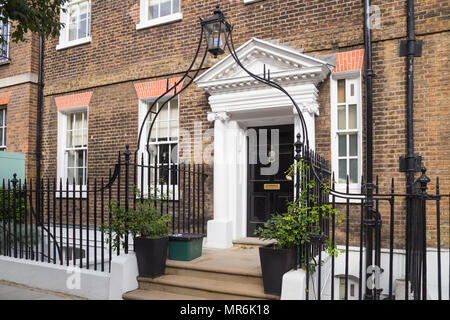 Pillared era Georgiana porta con lanterna ad arco titolare su John Street nel quartiere di Bloomsbury / Holborn, Londra WC1, Regno Unito Foto Stock