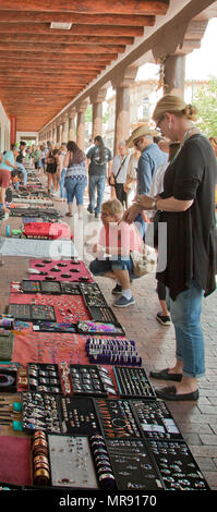 Una donna cerca su un bracciale in gioielli indiani Mercato che avviene quasi ogni giorno sotto il portale nord del palazzo dei Governatori su Sa Foto Stock