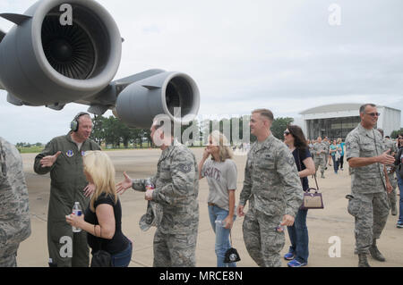 Equipaggio membri assegnati al Mississippi Air National Guard's 172nd Airlift Wing benvenuti i compagni di elementi ad ala e i loro coniugi ad un orientamento volo su una C-17 Globemaster al campo di Thompson a Jackson, in Mississippi, il 6 giugno. La 172d AW favorisce le relazioni in tutta la comunità e parafango con i membri della famiglia. Voli di orientamento sono un altro modo di costruire le relazioni e per istruire ulteriormente ala coniugi sui tipi di missioni condotte dall'172d AW. Air National Guard foto di Senior Airman Kiara Spann. Foto Stock