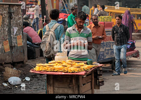 Delhi, India - 20 Novembre 2015: Un uomo indiano vendendo i suoi prodotti freschi in un affollato mercato di strada di Vecchia Delhi Foto Stock