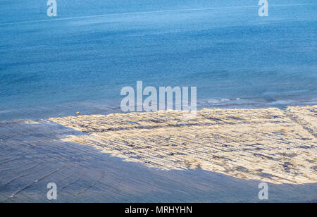 Vista su rocce esposte sulla spiaggia (popolare con i cacciatori di fossili) a bassa marea da scogliere a Saltburn dal mare, North Yorkshire, Inghilterra, Regno Unito Foto Stock