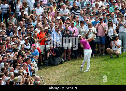 In Irlanda del Nord la Rory McIlroy colpisce della folla sul fairway prima durante il giorno quattro del 2018 BMW PGA Championship di Wentworth Golf Club, Surrey. Foto Stock