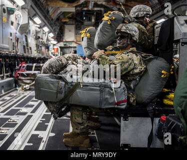 Stati Uniti Army Airborne paracadutisti dalla quarta brigata, XXV divisione di fanteria e paracadutisti canadese da Princess Patricia canadese della fanteria leggera sedersi sul bordo di una U.S. Air Force C-17, luglio 12, 2017 in attesa di airdrop nel supporto di esercizio talismano Saber 2017. Lo scopo di TS17 è migliorare U.S.-Australian Combat Readiness, aumentare l'interoperabilità, combinato a massimizzare le opportunità di formazione e di condotta di preposizionamento marittimo e le operazioni di logistica nel Pacifico. TS17 dimostra anche l'impegno degli Stati Uniti per il suo alleato fondamentale e globale del quadro di sicurezza nell'Indo Asian Pacific ri Foto Stock