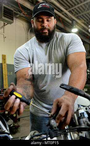 Corey Williams, Fort Eustis Auto Craft Centre e la stazione di controllo meccanico, effettua la manutenzione su un motociclo a base comune Langley-Eustis, Va., 28 giugno 2017. Williams ha trascorso otto anni negli Stati Uniti Esercito come un meccanico e distribuito due volte in Iraq prima di ritornare per il settore civile come meccanico presso l'auto centro. (U.S. Air Force foto/Staff Sgt. Teresa J. Cleveland) Foto Stock