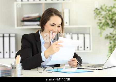 Felice lavoratore di ufficio per leggere le notizie di una lettera su carta Foto Stock