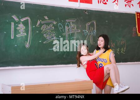 Taiyuan, Taiyuan, Cina. 27 Maggio, 2018. Taiyuan, Cina-27Maggio 2018: due neolaureate prendere creative foto di graduazione di diversi temi tra cui foto di nozze e la squadra di basket a Shanxi University di Taiyuan, Cina del nord della provincia di Shanxi. Credito: SIPA Asia/ZUMA filo/Alamy Live News Foto Stock