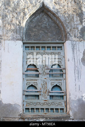 Scolpita in legno finestra di una casa abbandonata, Dhofar Governatorato, Mirbat, Oman Foto Stock