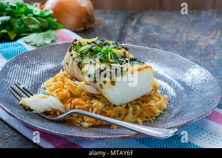 Grigliata di coriandolo e limone cod con la carota pilaf Foto Stock