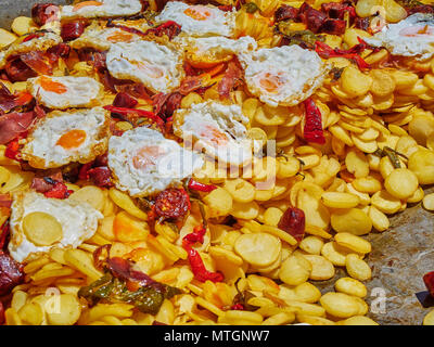 Uova di spagnolo. Uova fritte con chorizo, patate e peperoni in padella. Lo spagnolo street food. Foto Stock