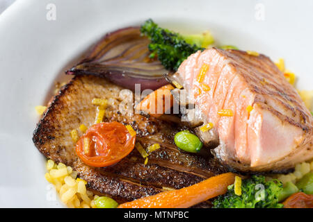 Filetto di salmone alla griglia con verdure sulla piastra bianca Foto Stock