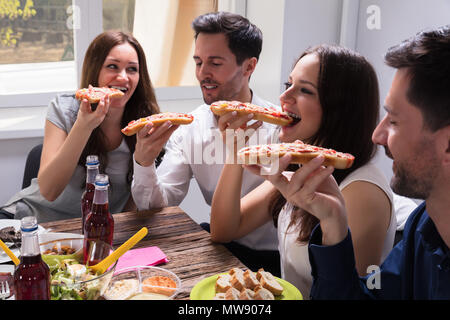 Ritratto di Felice giovani amici di mangiare freschi e deliziosi Bruschetta Foto Stock
