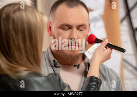 Make-up dell'uomo attore prima di effettuare le riprese da vicino Foto Stock