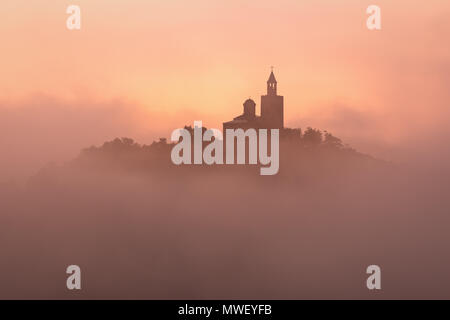 Incredibile bellissima vista sulla fortezza di Tsarevets a Veliko Tarnovo, Bulgaria su un foggy sunrise in estate. Foto Stock