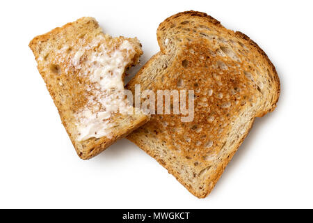 Mezza mangiata imburrato fetta di frumento integrale tostato e asciugare tutta la fetta di pane tostato isolato su bianco dal di sopra. Foto Stock