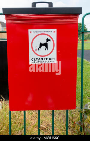 Un vassoio di colore rosso per mettere dog poo in, dopo pulizia dopo il vostro cane fa un pasticcio. Foto Stock