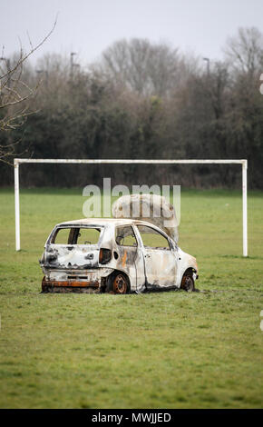 Bruciata furto di auto abbandonate su una comunità di calcio accanto a un consiglio estate in Hampshire Foto Stock