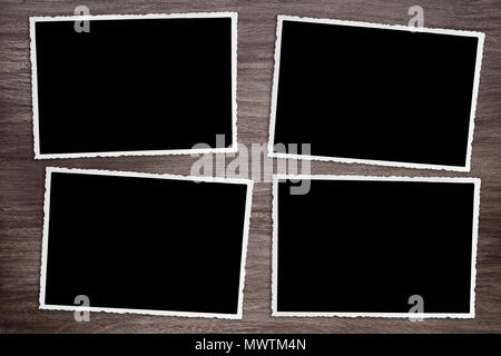 Quattro annerito vintage vecchi modelli fotografici sul rustico sfondo di legno Foto Stock