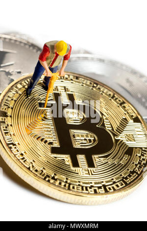 Lavoratore in miniatura Bitcoin Mining su una superficie bianca Foto Stock