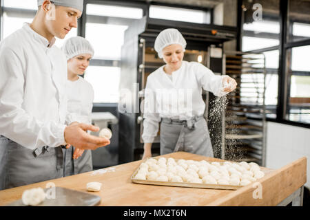 Fornai rendendo i panini a livello di fabbricazione Foto Stock