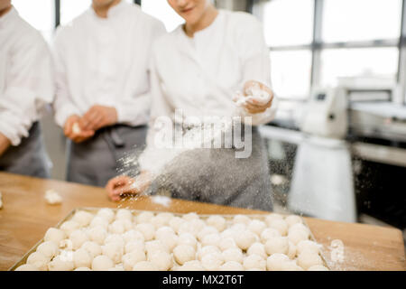 Fornai rendendo i panini a livello di fabbricazione Foto Stock