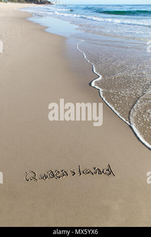 Burleigh Beach Queensland Australia è una delle migliori spiagge in Australia. Queensland scritto nella sabbia con una piccola onda la laminazione in frame. Foto Stock