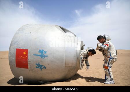 (180603) -- PECHINO, 3 giugno 2018 (Xinhua) -- Taikonauts Nie Haisheng (L) e Liu Wang esce da una capsula di rientro durante un deserto per la sopravvivenza della formazione in Badain Jaran deserto nel nord-ovest della Cina di Provincia di Gansu, 17 maggio 2018. Quindici taikonauts cinesi hanno appena completato il deserto di formazione di sopravvivenza nel profondo del Badain Jaran deserto vicino Jiuquan Satellite Launch Center nel nord ovest della Cina. Organizzato dall'astronauta centro della Cina (ACC), il programma è stato concepito per preparare taikonauts con la capacità di sopravvivere nel deserto in caso la loro capsula di rientro terre al di fuori del target. (X Foto Stock