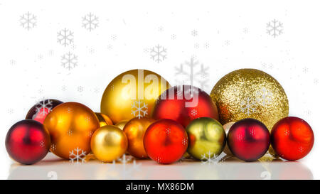 Multicolore palle di Natale su sfondo bianco con i fiocchi di neve ovunque Foto Stock