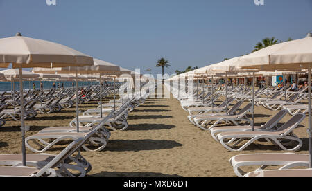 Larnaca, Cipro, Makenzie beach. Vuoto di sedie a sdraio e ombrelloni sulla sabbia Foto Stock