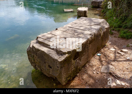 Pietra originale dalla distrutta Stari Most (Ponte Vecchio) sul lato a valle del fiume Neretva, Mostar Bosnia. Foto Stock