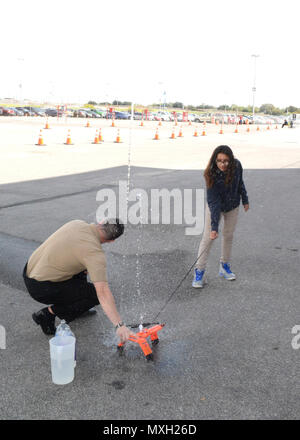 SAN ANTONIO - (nov. 1, 2016) Bridgman, Mich native, Sottufficiali di prima classe Ian MacKay, un campo nucleare assegnato coordinatore marina al reclutamento di quartiere San Antonio, assiste una middle school girl in una bottiglia di acqua il lancio del razzo durante quella ispanica Camera di Commercio CORE4 stelo Expo che si terrà presso il Freeman Expo Hall. MacKay è un 2005 laureato di Bridgman High School. L'expo, costituito un giorno femmina e maschio di giorno, leader in primo piano dall'energia, scienza, computer e industrie aerospaziali e presentata agli studenti l opportunità di incontrare di alto profilo rappresentanti da Fort Foto Stock