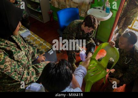 Provincia di Sabah, Malesia (11 novembre 2016) - Cmdr. Erin Griffith, xi Marine Expeditionary Unit chirurgo, esamina un uomo locale è la gamba durante una visita medica per gli affari civili progetto durante l'esercizio Tiger Strike 2016 nella provincia di Sabah, Malesia, nov. 11. Il personale medico dal XI MEU e malese forze armate teamed in su con i professionisti locali per fornire cure di base e il trattamento di pazienti civile presso una delle locali Lahad Datu cliniche. Tiger colpire 16 è un esercizio di bilaterali tra la Makin Island anfibio gruppo pronto/xi MEU e MAF Concepita per migliorare la comunicazione e il coordinamento Foto Stock