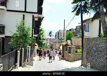 I turisti a piedi giù collina ripida a Ohrid Macedonia. Street view. Foto Stock