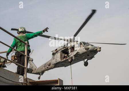 161123-N-RX777-209 GOLFO ARABICO (nov. 23, 2016) Petty Officer 2a classe Giulietta Scarlott dirige un MH-60S Sea Hawk elicottero assegnato per il polveroso cani di elicottero di mare squadrone di combattimento (HSC) 7 durante un rifornimento verticale a bordo del combattimento veloce nave appoggio USNS Arctic (T-AOE 8). Artico è implementato il supporto di coalizione forze marittime navi negli Stati Uniti Quinta Flotta area di operazioni. (U.S. Navy foto di Sottufficiali di terza classe Cole Keller) Foto Stock