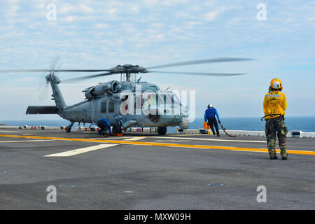 Un elicottero MH-60S Knighthawk dell'Helicopter Sea Combat Squadron 28 è assicurato al ponte di volo della USS Iwo Jima (LHD-7) nell'Oceano Atlantico il 5 dicembre 2016 durante le operazioni di volo. Il Knighthawk è un elicottero multi-missione alimentato da due motori turboalbero T700-GE-401C, in grado di combattere contro la superficie, ricerca e salvataggio, rifornimento verticale e evacuazione medica. LHD-7 supporta operazioni anfibie marine, integrazione dell'aviazione ed esercizi di certificazione pre-implementazione. Foto Stock
